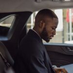 Driver reviewing legal documents inside a car after an accident