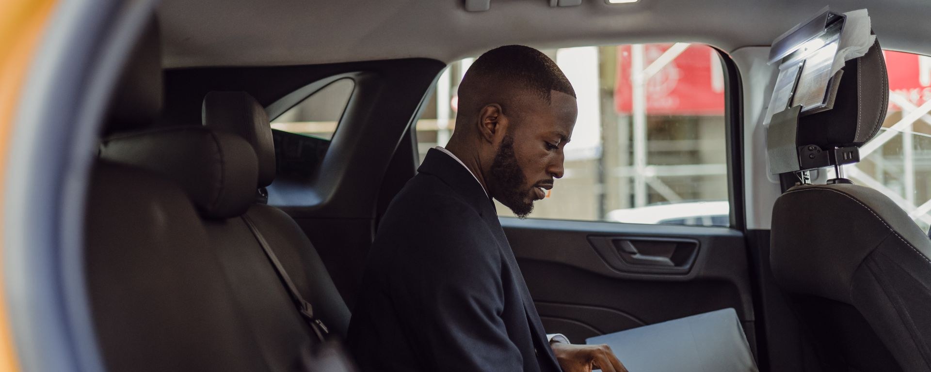 Driver reviewing legal documents inside a car after an accident