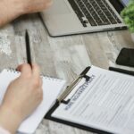 Couple reviewing auto insurance policy documents with an insurance agent